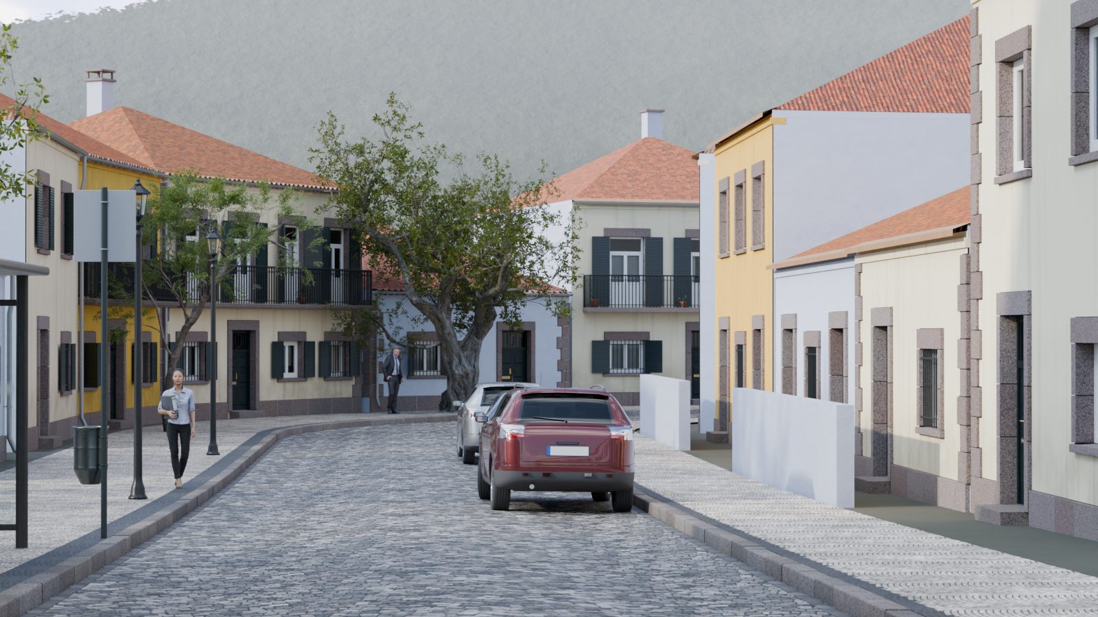 Estrada a sair da vila, entre casas baixas e colinas.