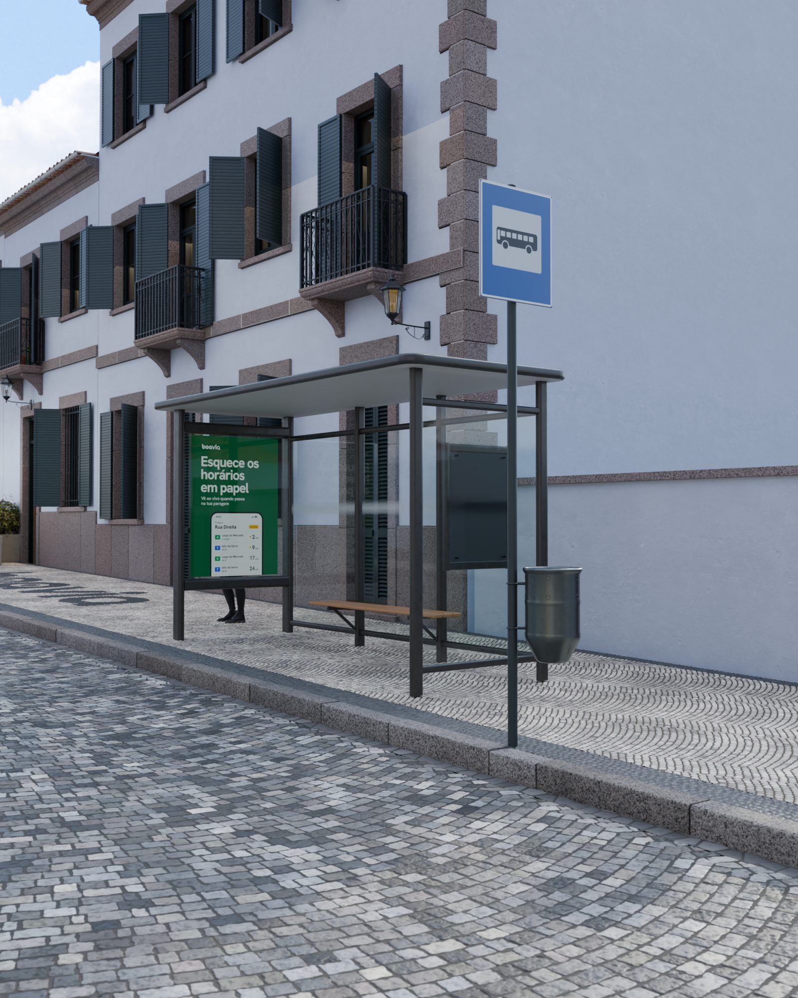 Abrigo de paragem e o respetivo sinal, ao fundo da rua, de manhã.